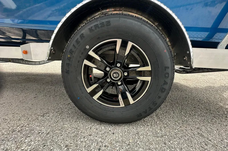 Slide: The Image of 2026 Vexus Defender 201 wheel with Karrier KR35 tire on asphalt. - 35