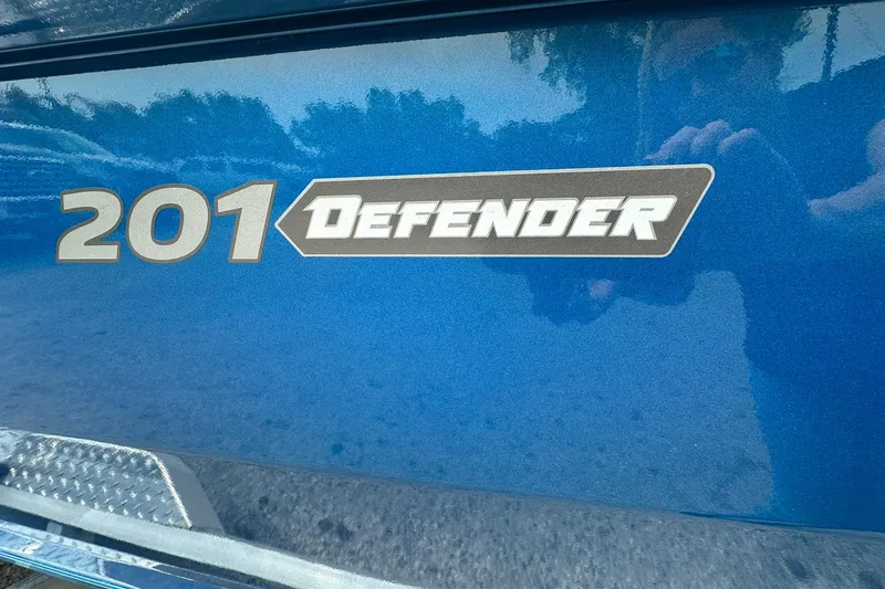 Slide: The Image of 2026 Vexus Defender 201 logo on a shiny blue surface. - 38