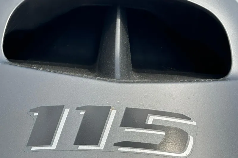 Slide: The Image of Close-up of Vexus Defender 201 engine cover with "115" marking, 2026 model. - 40