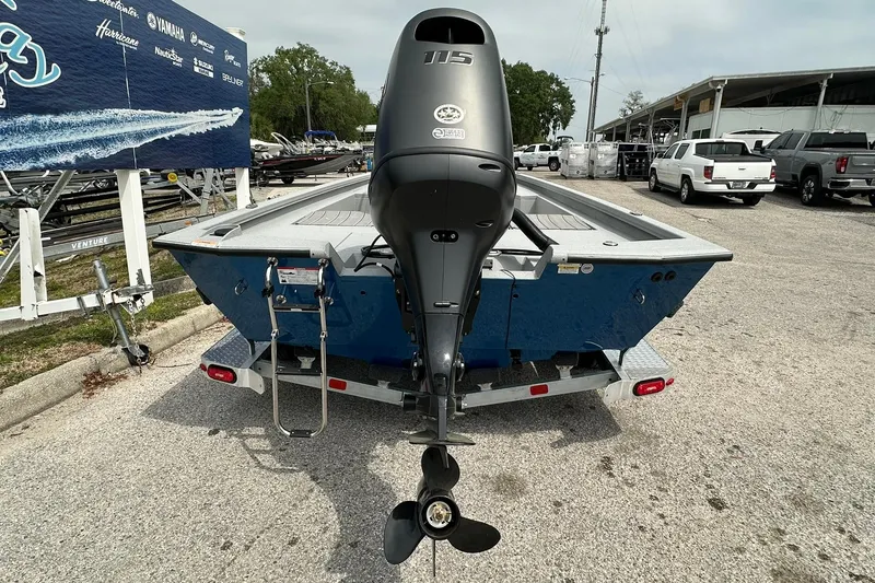 Slide: The Image of 2026 Vexus Defender 201 boat with Yamaha 115 engine, parked on a trailer. - 41