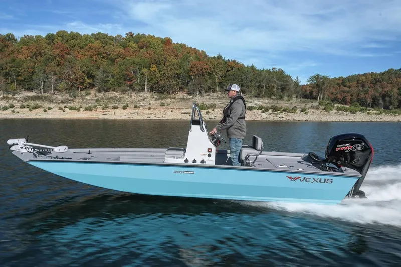 Slide: The Image of Manufacturer Provided Image: 2026 Vexus Defender 201 boat cruising on a lake with scenic forest backdrop. - 45