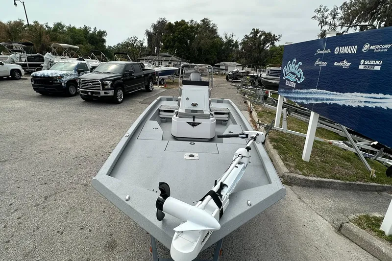 Slide: The Image of 2026 Vexus Defender 201 boat displayed at a marina with vehicles nearby. - 5