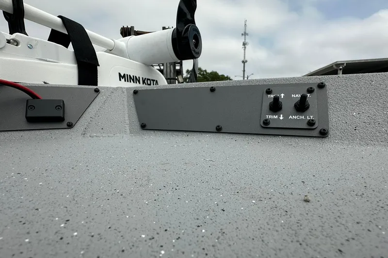 Slide: The Image of 2026 Vexus Defender 201 boat dashboard with Minn Kota motor and control switches. - 9