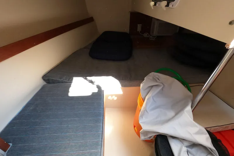 Slide: The Image of Interior cabin of a 1990 Catalina Capri 26 sailboat with cushions and storage items. - 13