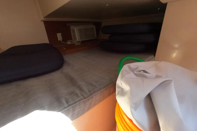 Slide: The Image of Interior cabin of a 1990 Catalina Capri 26 sailboat with cushions and storage. - 14