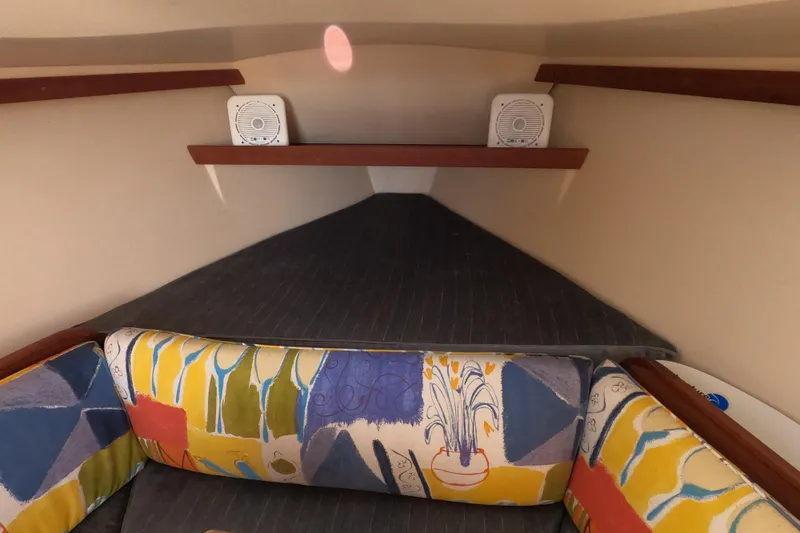 Slide: The Image of Interior of 1990 Catalina Capri 26 sailboat with colorful cushions and speakers. - 19