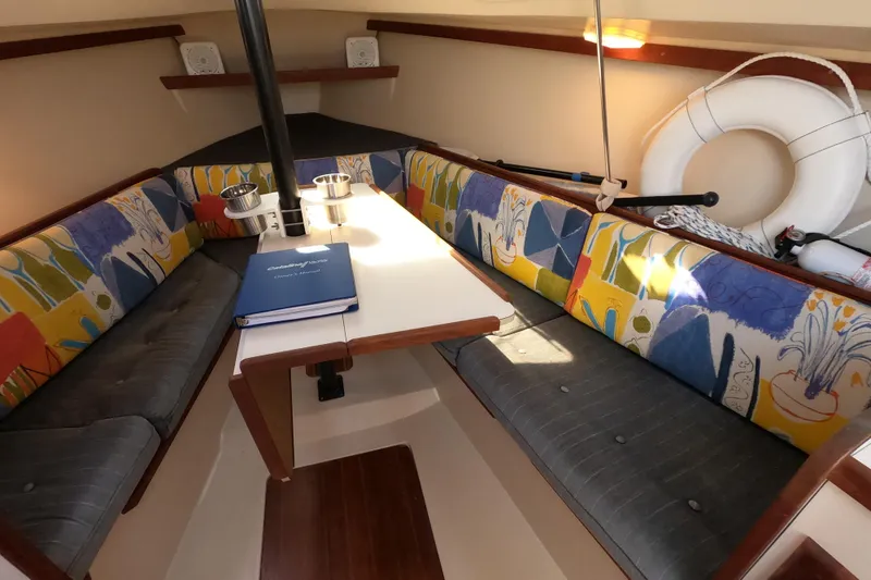 Slide: The Image of Interior of 1990 Catalina Capri 26 sailboat with colorful seating and table. - 20