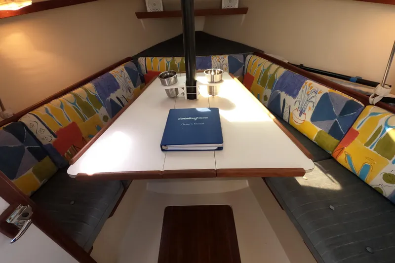 Slide: The Image of Cozy interior of 1990 Catalina Capri 26 sailboat with colorful seating and table. - 21