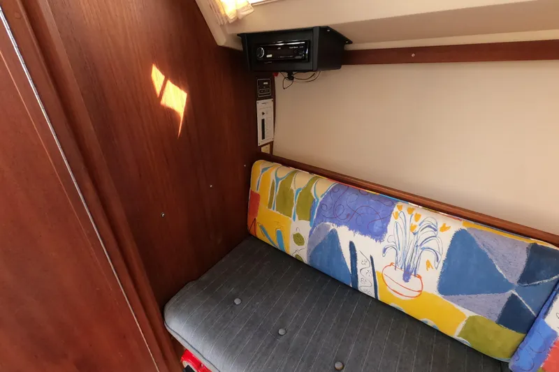 Slide: The Image of Interior of 1990 Catalina Capri 26 with colorful cushion and wooden paneling. - 22