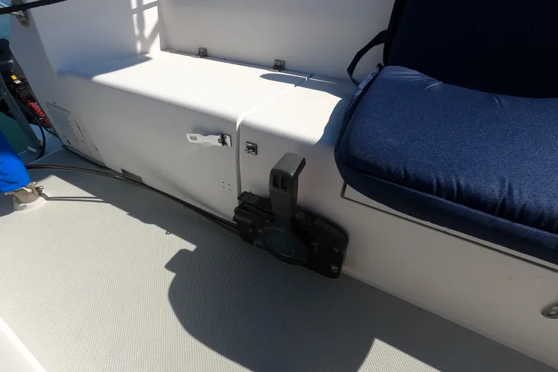 Slide: The Image of Interior of a 1990 Catalina Capri 26 sailboat with blue cushioned seating. - 24