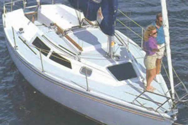 Slide: The Image of 1990 Catalina Capri 26 sailboat on water with two people on deck. - 26