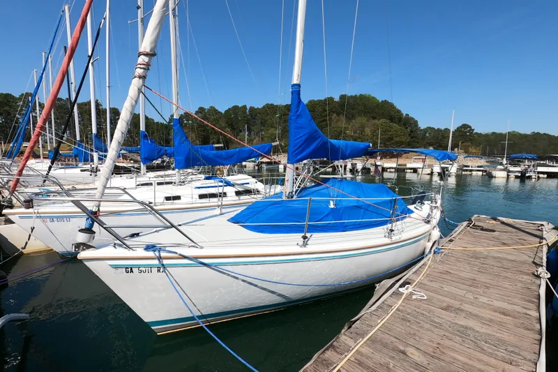 Slide: The Image of 1990 Catalina Capri 26 sailboat docked at marina with blue covers. - 3
