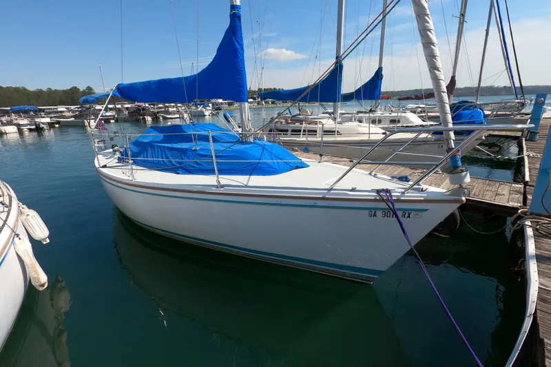 Slide: The Image of 1990 Catalina Capri 26 sailboat docked at marina with blue covers. - 4