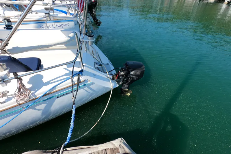 Slide: The Image of Catalina Capri 26 sailboat with outboard motor docked in clear water, 1990 model. - 6