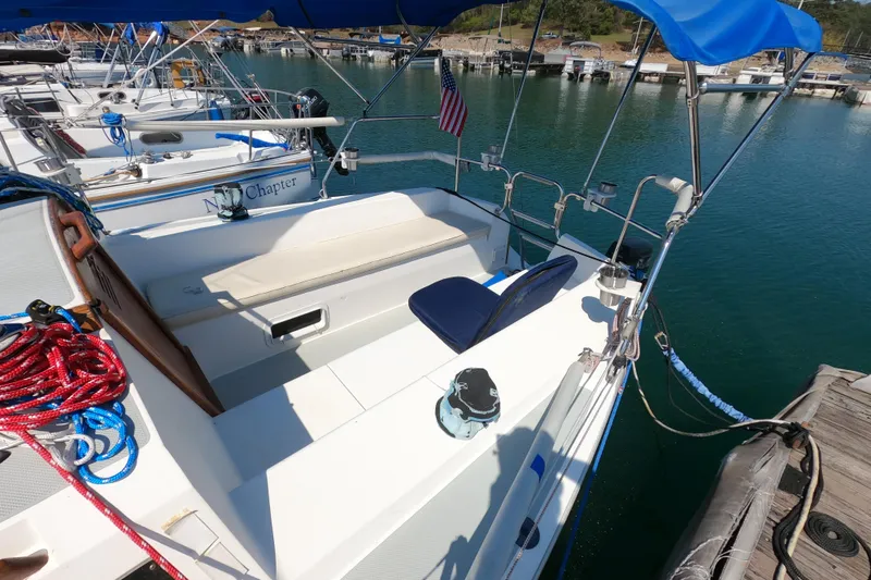 Slide: The Image of Catalina Capri 26 sailboat, 1990 model, docked with blue canopy and American flag. - 7
