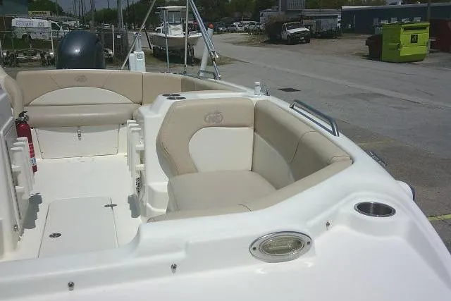 Slide: The Image of 2018 NauticStar 193 SC Deck boat interior with beige seating and cup holders. - 14