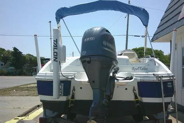 Slide: The Image of 2018 NauticStar 193 SC Deck boat with Yamaha 115 engine, parked outdoors. - 9