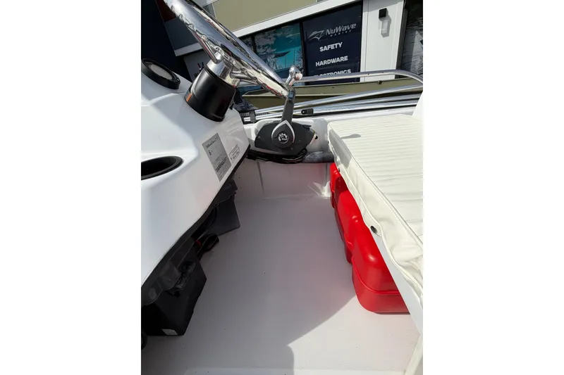 Slide: The Image of 2004 Boston Whaler 150 Sport interior with steering wheel and seating area. - 10