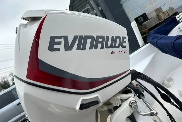 Slide: The Image of Evinrude E-TEC outboard motor on a 2004 Boston Whaler 150 Sport boat. - 14