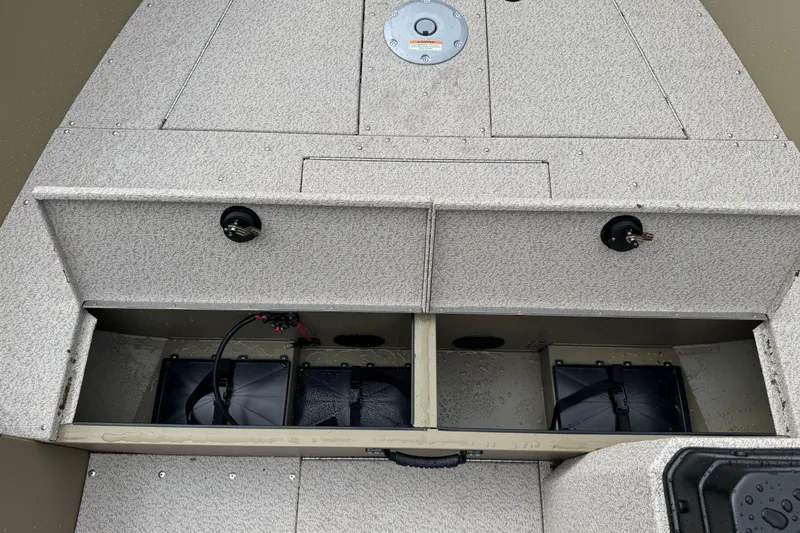 Slide: The Image of 2026 Lund 2075 Alaskan SS boat interior with storage compartments and battery setup. - 10