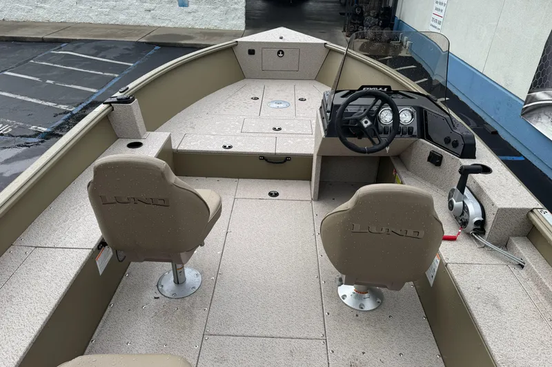 Slide: The Image of 2026 Lund 2075 Alaskan SS boat interior with steering console and seating. - 12