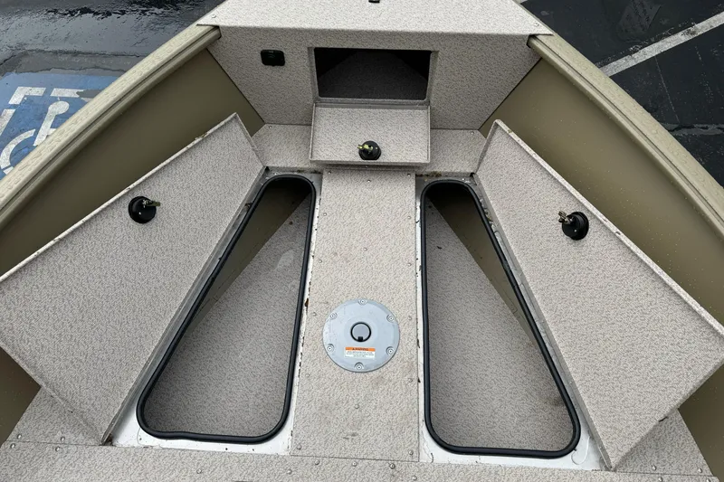 Slide: The Image of 2026 Lund 2075 Alaskan SS boat interior with open storage compartments. - 14