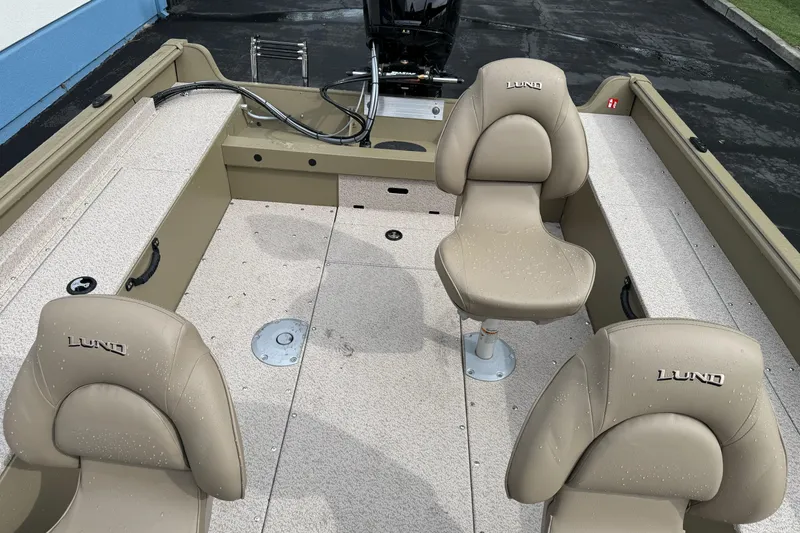 Slide: The Image of 2026 Lund 2075 Alaskan SS boat interior with beige seats and spacious layout. - 16