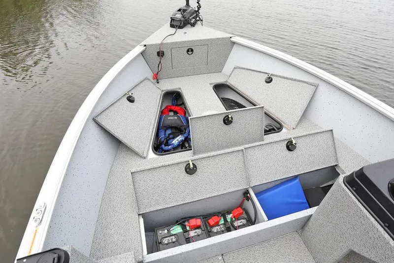 Slide: The Image of Manufacturer Provided Image: 2025 Lund 2075 Alaskan SS boat with open storage compartments on calm water. - 3