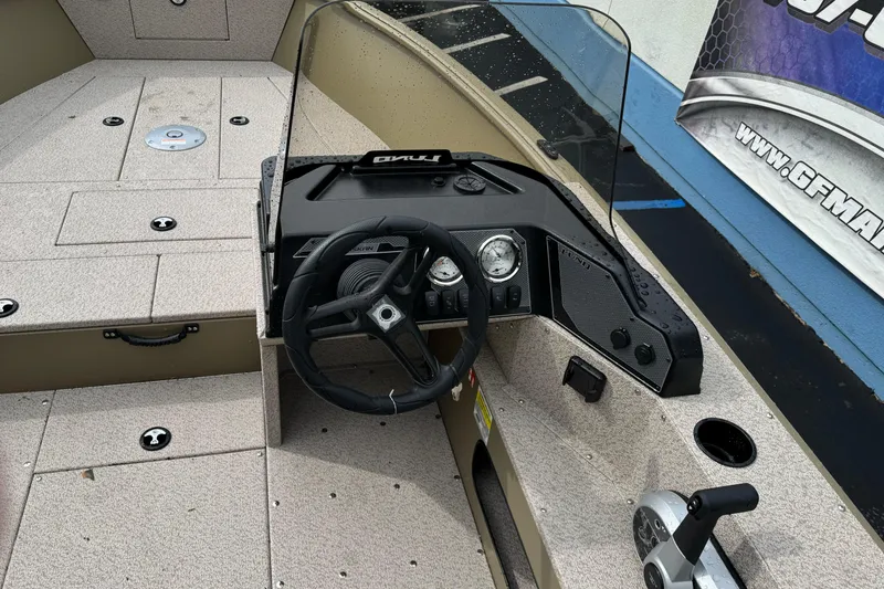 Slide: The Image of 2026 Lund 2075 Alaskan SS boat dashboard with steering wheel and controls. - 8