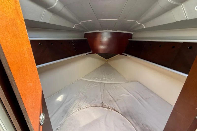 Slide: The Image of Interior cabin of 1990 Beneteau First 32s5 sailboat, featuring cozy sleeping quarters. - 10