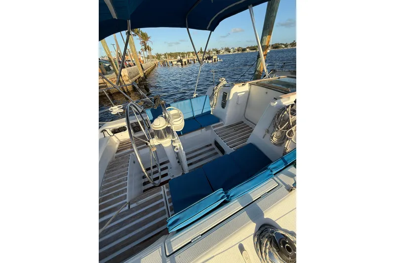 Slide: The Image of Cockpit of 1990 Beneteau First 32s5 sailboat with blue seating and steering wheel. - 14