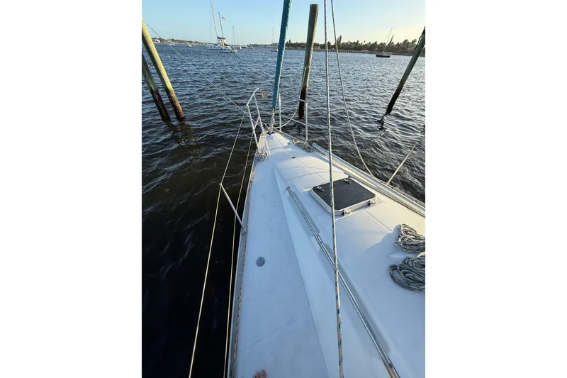 Slide: The Image of Sailboat deck view of 1990 Beneteau First 32s5 moored by wooden posts. - 17