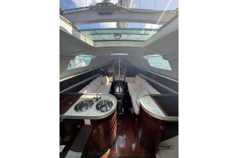 Slide: The Image of Interior of 1990 Beneteau First 32s5 sailboat with modern kitchen and seating area. - 24