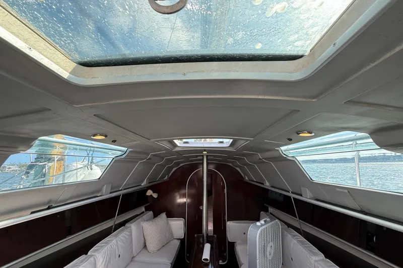 Slide: The Image of Interior of 1990 Beneteau First 32s5 sailboat with skylight and seating area. - 28