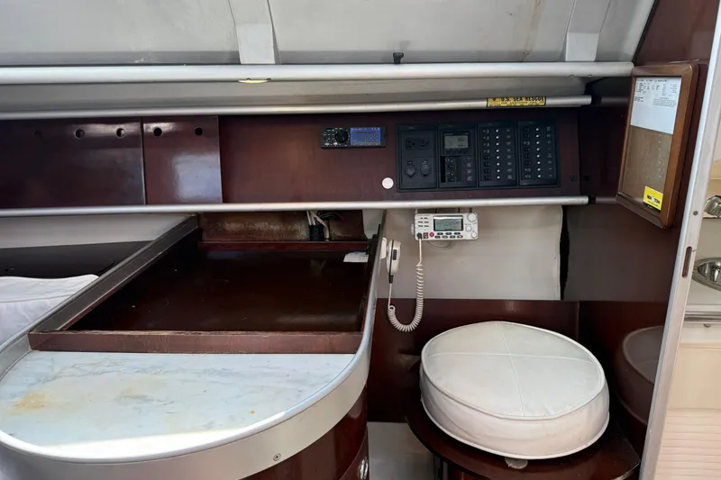 Slide: The Image of Interior of 1990 Beneteau First 32s5 sailboat with navigation equipment and seating area. - 30