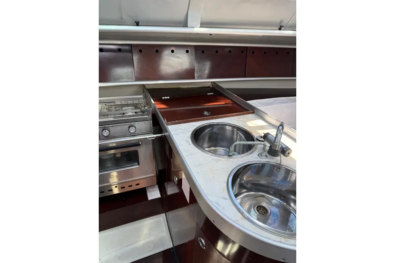Slide: The Image of Galley kitchen in 1990 Beneteau First 32s5 yacht with stove and dual sinks. - 33