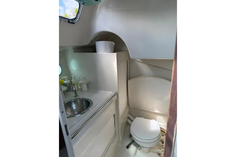 Slide: The Image of Bathroom interior of 1990 Beneteau First 32s5 yacht, featuring sink and toilet. - 35