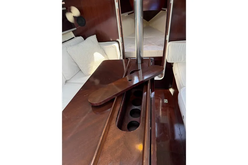 Slide: The Image of Interior of 1990 Beneteau First 32s5 yacht with wooden table and seating area. - 37