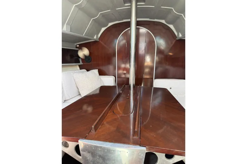 Slide: The Image of Interior of 1990 Beneteau First 32s5 sailboat with wooden table and seating. - 39