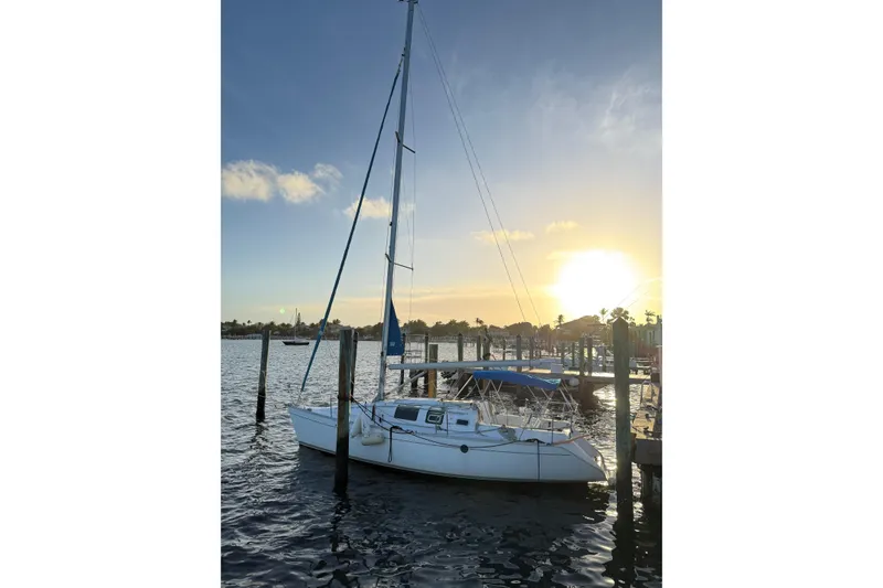 Slide: The Image of Sailboat Beneteau First 32s5, 1990 model, docked at sunset with calm waters. - 4
