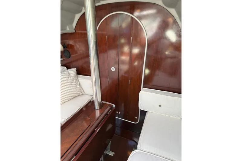 Slide: The Image of Interior of 1990 Beneteau First 32s5 sailboat with wood paneling and white seating. - 41