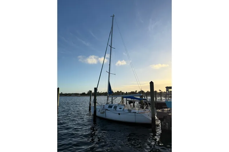 Slide: The Image of Sailboat Beneteau First 32s5, 1990 model, docked at sunset with clear sky. - 5