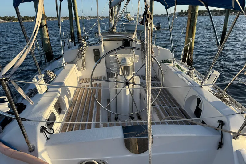 Slide: The Image of Cockpit of a 1990 Beneteau First 32s5 sailboat, docked on calm waters. - 7
