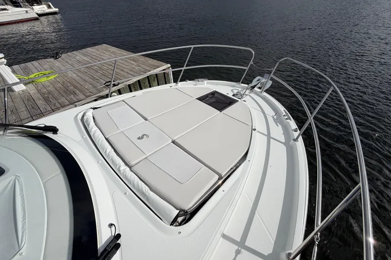 Slide: The Image of 2026 Beneteau Antares 11 Fly yacht with sunbathing deck, docked by the water. - 10