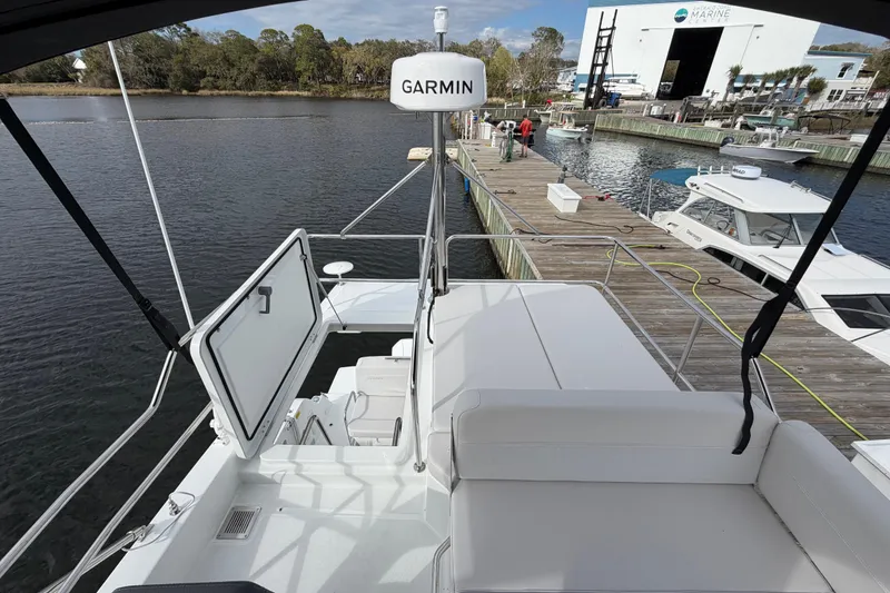 Slide: The Image of 2026 Beneteau Antares 11 Fly yacht docked, featuring Garmin navigation equipment. - 12