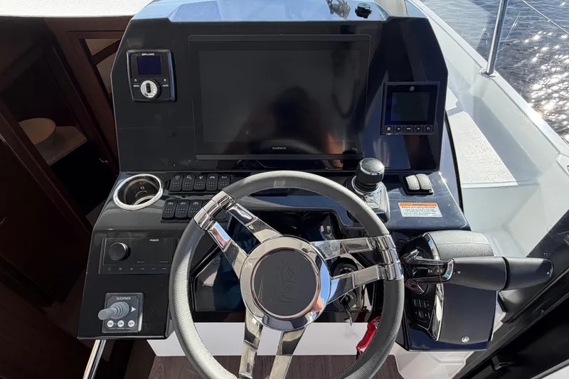 Slide: The Image of Helm of 2026 Beneteau Antares 11 Fly with modern controls and navigation display. - 13