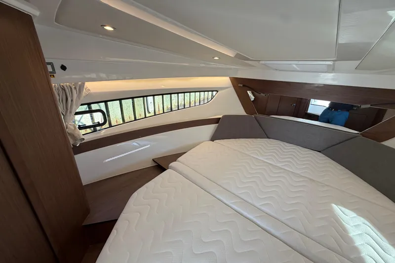 Slide: The Image of Interior cabin of 2026 Beneteau Antares 11 Fly with modern design and cozy bedding. - 17