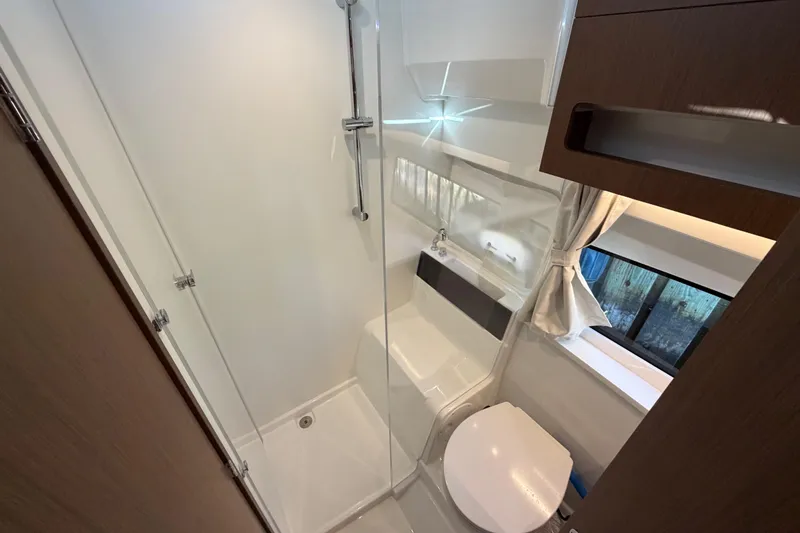 Slide: The Image of Bathroom interior of 2026 Beneteau Antares 11 Fly, featuring shower and toilet. - 20