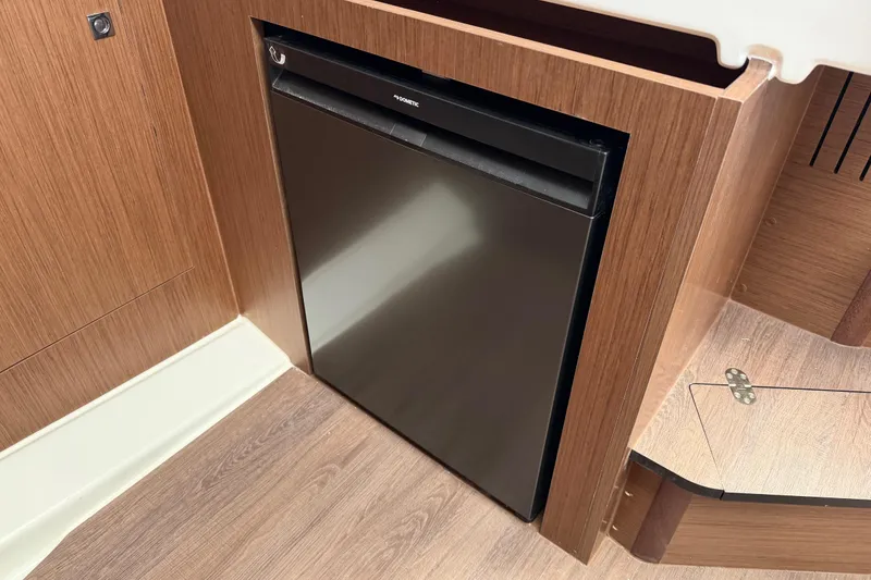 Slide: The Image of Compact refrigerator in the 2026 Beneteau Antares 11 Fly yacht interior. - 21