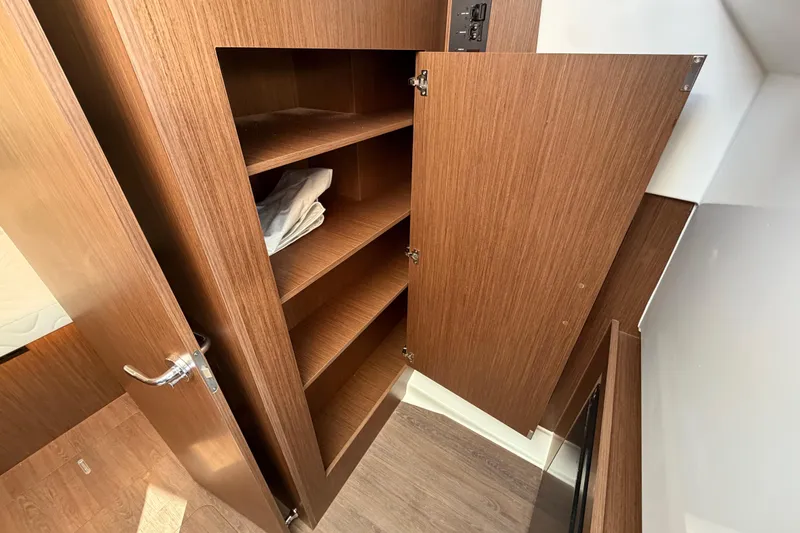 Slide: The Image of Wooden storage cabinet inside 2026 Beneteau Antares 11 Fly boat. - 22